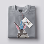 Folded t-shirt with a printed graphic of an ass or donkey wearing a dunce cap